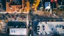 Aerial photograph of a four-way intersection with cars waiting on all sides.