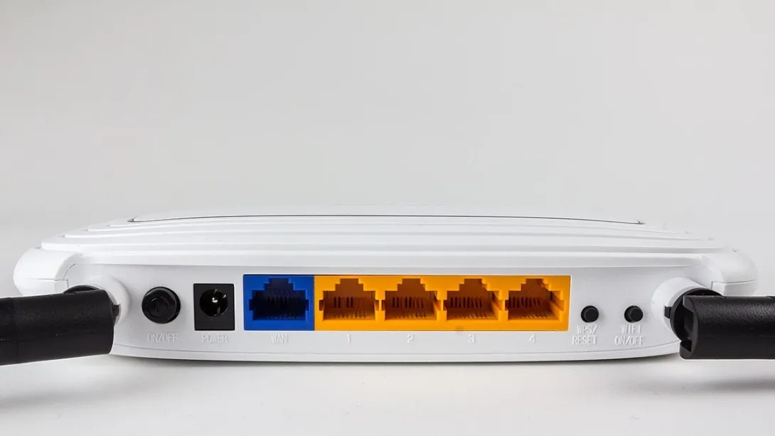 A TP-Link Wi-Fi router with two antennas sitting on a surface.